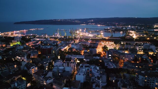 Aerial view of Varna port and illuminated city bay at twilight, Bulgaria