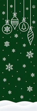 Christmas ornaments hanging against green background with snowflakes and snow