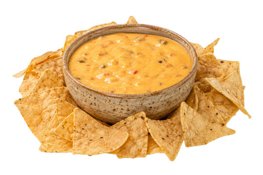 Delicious bowl of creamy yellow queso dip with peppers, surrounded by crispy tortilla chips, isolated on a white background