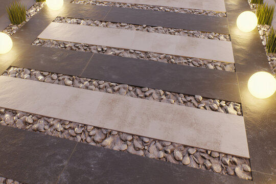 Contemporary outdoor garden pathway featuring alternating light and dark stone paving slabs separated by decorative gravel. Warm glowing spherical landscape lights and ornamental plants