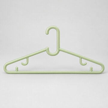 Pastel Green Plastic Clothes Hanger Isolated on a Light Studio Background