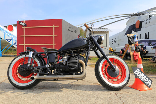 Kyiv, Ukraine - October 01, 2016: Custom bobber motorcycle with red wheels and white wall tires