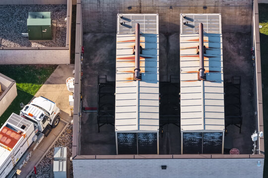 Aerial view of industrial rooftop units and service truck