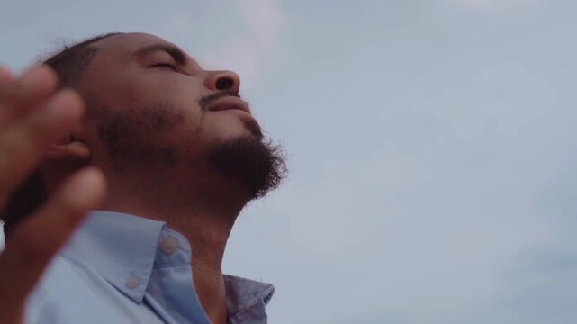 African american male praying and worshipping outdoors