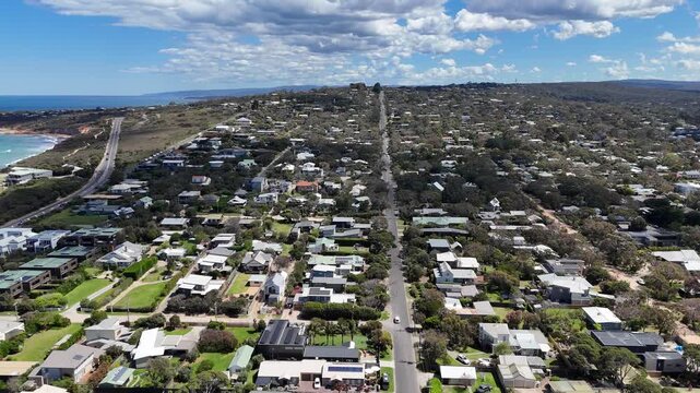 Aerial drone view over the coastal town of Anglesea on Victoria&rsquo;s Great Ocean Road, Australia, revealing a densely wooded low-density residential township and natural bushland