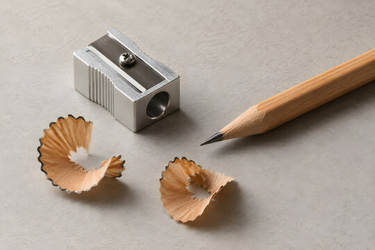 Metal Pencil Sharpener with a Graphite Pencil and Wood Shavings