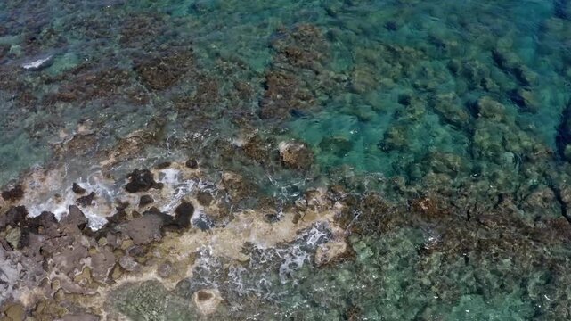 Drone flight over a rocky coast with sea surf near Kolymbari, West Crete, Crete, Greece