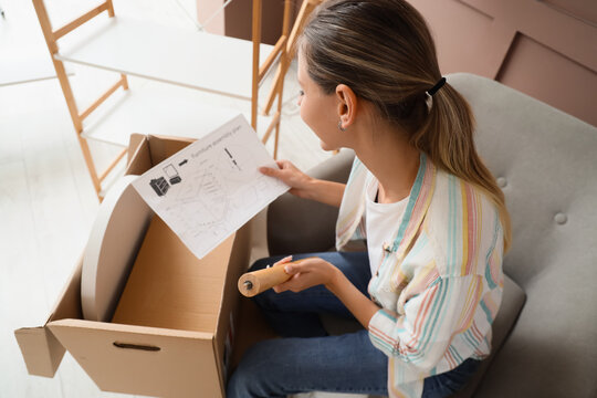 Home improvement and furniture assembly, woman reading instruction manual while building new furniture at home for interior design and renovation