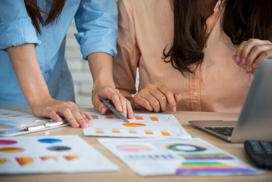 Asian Two woman Business people working Together at home office. Teamwork collaboration teamwork concept. start up business partners enjoy good news from smartphone. Two businesswomen talking