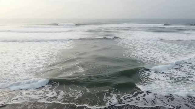 Dangerous rip current flowing through ocean waves along the sandy