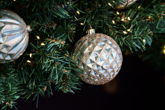 Silver Christmas Bauble Hangs Among Glowing Tree Lights