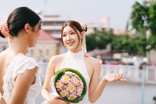  Two young asian women sightseeing in Bangkok, Thailand trend fashion with oriental aesthetic flower accessories