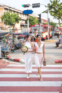 Two young asian women sightseeing in Bangkok, Thailand trend fashion with oriental aesthetic flower accessories