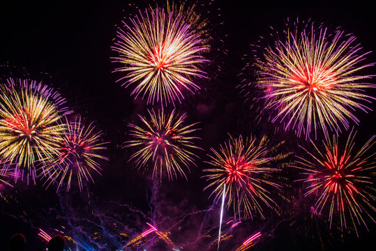 Purple firework in night time celebrate national holiday. Purple Firework celebrate anniversary happy new year 2027, 4th of july holiday festival. Violet firework Countdown to new year 2026 festival