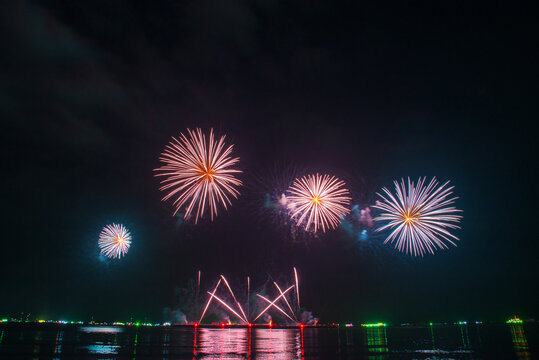 Pink Purple firework in night time celebrate national holiday. Purple Firework celebrate anniversary happy new year 2027, 4th of july holiday festival. Pink firework Countdown to new year 2026