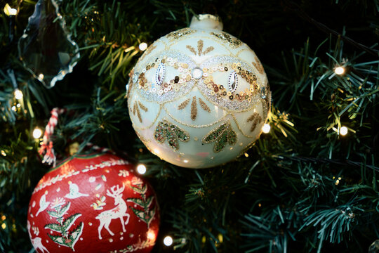 Ornate Christmas Baubles Hang Among Warm Fairy Lights