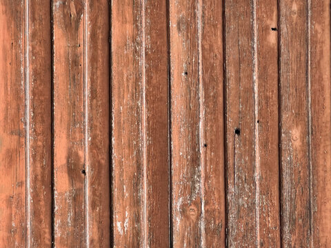 Weathered reddish brown wooden planks with distressed paint, visible natural grain, cracks and rustic texture, wood background