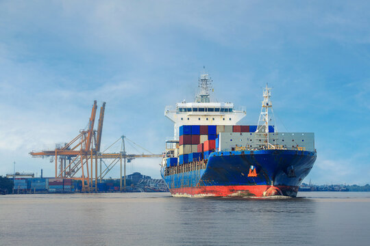 Majestic cargo container ship sails on deep sea water for global ocean freight transport near busy commercial shipping port