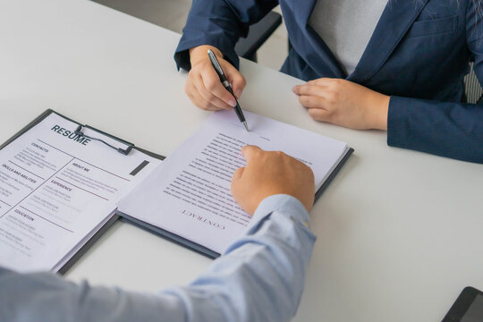Asian business people sent documents to boss for sign in office room