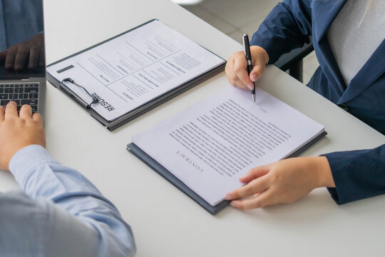 Asian business people sent documents to boss for sign in office room