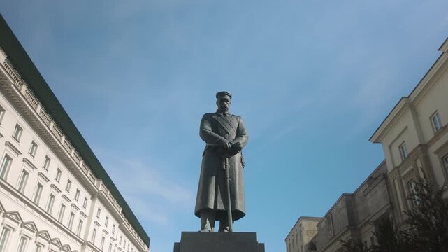 Low angle shot of the bronze statue of Jozef Pilsudski in Warsaw, Poland. Ideal for historical documentaries, European travel guides, and educational content about Polish history.