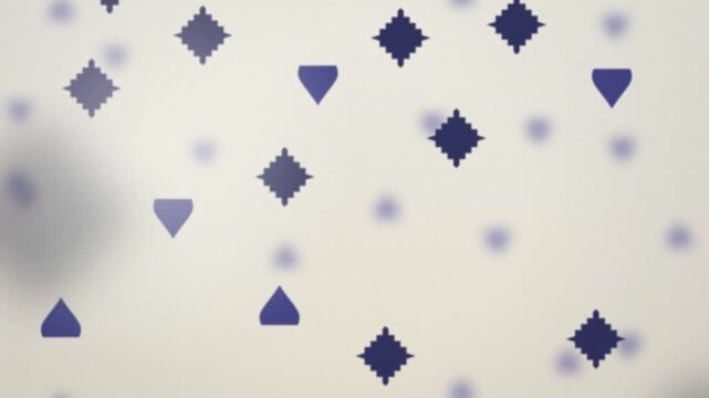 Geometric icon shapes falling seamless loop motion background