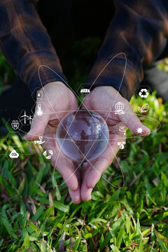 Hand Cupping Glass Globe with Green Technology and Environmental Protection Icons