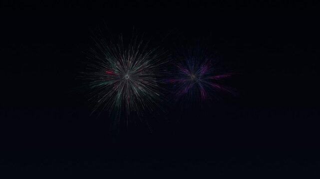 Two colorful fireworks exploding against dark night sky digital motion background