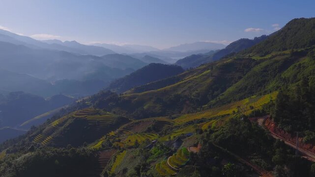 Aerial view of golden rice terraces at Mu Cang Chai town near Sapa city, North of Vietnam. Beautiful terraced rice field in harvest season in Lao Cai province.