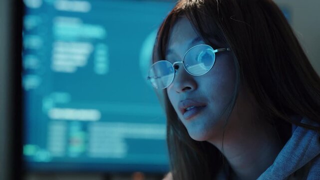 AI software engineer reading code, young Asian woman with glasses and AI icon reflection at night