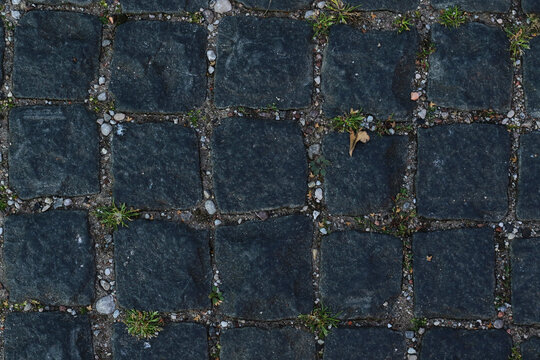 texture of grey, rough, paving stones road