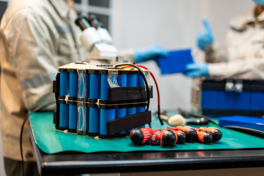Bomb disposal technicians examine a suspected improvised explosive