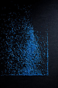 Blue sand background on black cardboard