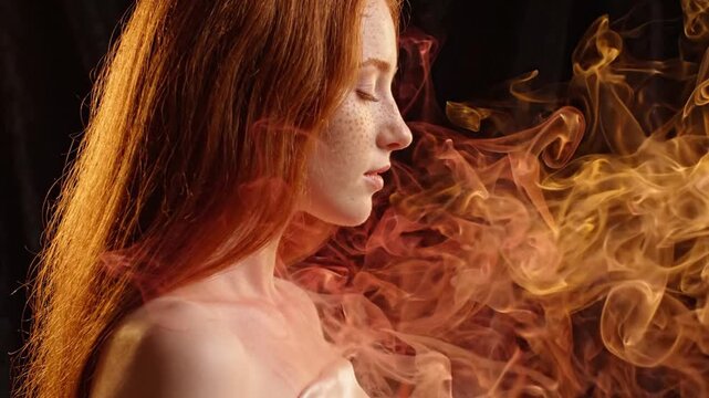 Redheaded woman with freckles eyes closed near red smoke