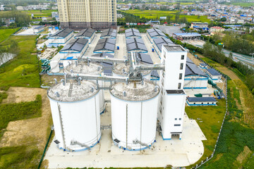 aerial view of large industrial white storage tanks and factory complex © zhangyang135769