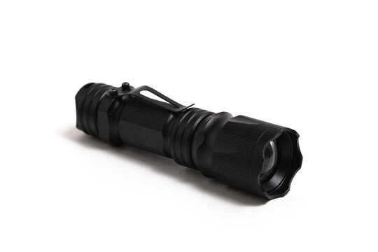 Black tactical LED flashlight with pocket clip isolated on white background, angled view.