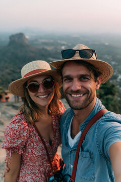 Selfie in Asia smiling stylish couple overlooking spectacular mountain landscape during unforgettable Indian travel vacation with panoramic scenic views