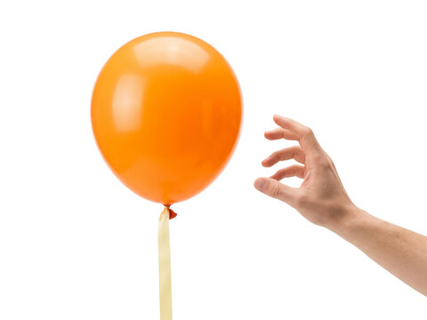 Hand Releasing Orange Balloon Into Air transparent background
