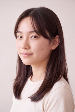 Natural clean headshot of young woman with straight hair for corporate profile and website