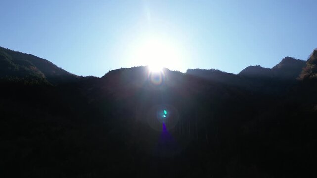 Aerial Drone View of Sunbeams Streaming Over a Mountain Peak