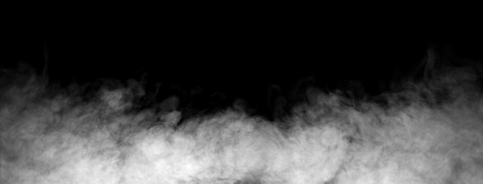 Dense white smoke or fog rolling across the bottom on a black background. Concept of abstract vapor texture, atmospheric mist overlay, and dramatic special effect background.