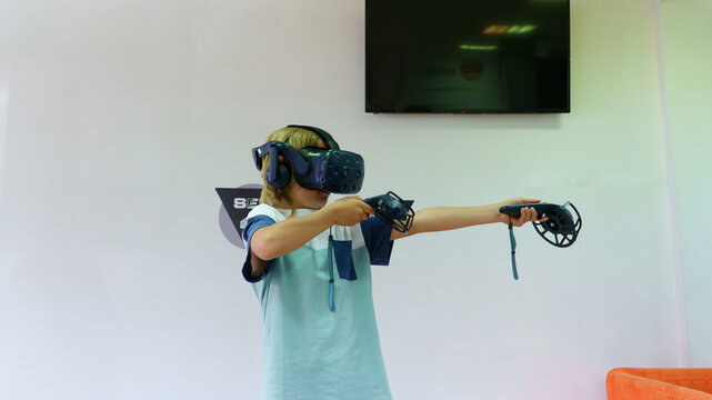 Boy playing virtual reality game with vr headset
