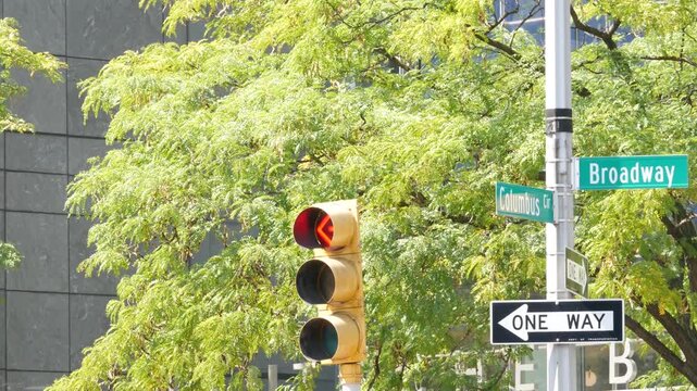 New York City Broadway street sign on Manhattan, United States. Urban road sign in american city. Traffic sign in Midtown of NYC USA. Traffic light near Columbus circle and Central Park. One way arrow