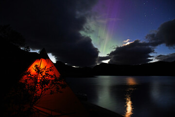 Colorful northern lights while camping in mountains in Norway © Honza