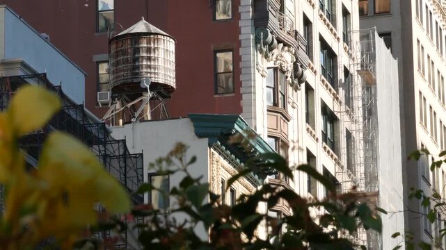 New York City urban building architecture, Manhattan rooftop, United States of America. Water tower on roof. Classic water tanks.
