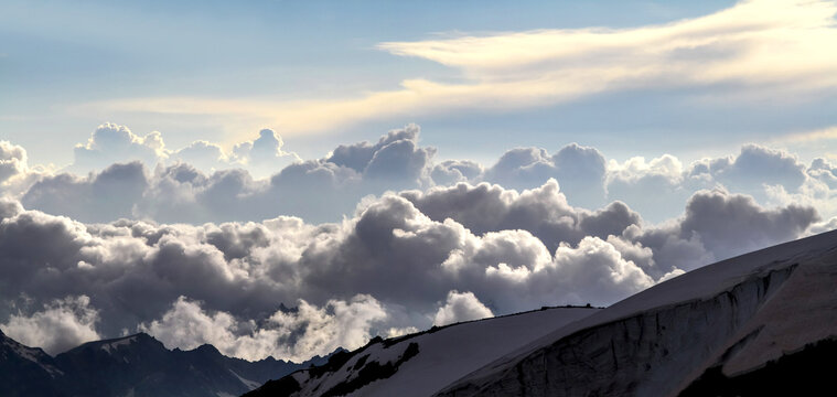 Snowy mountain peaks above a sea of clouds