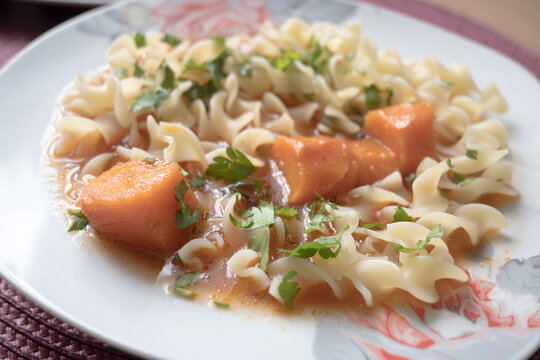 Tomato soup with pasta and parsley &ndash; a warm, homemade meal.
