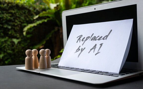 Replaced by AI - message on top of computer laptop