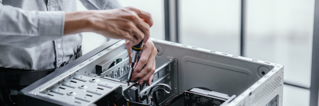 computer technician upgrades PC hardware in a workspace environment