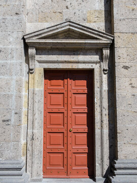 Elegant Red Double Door in a Weathered Stone Wall